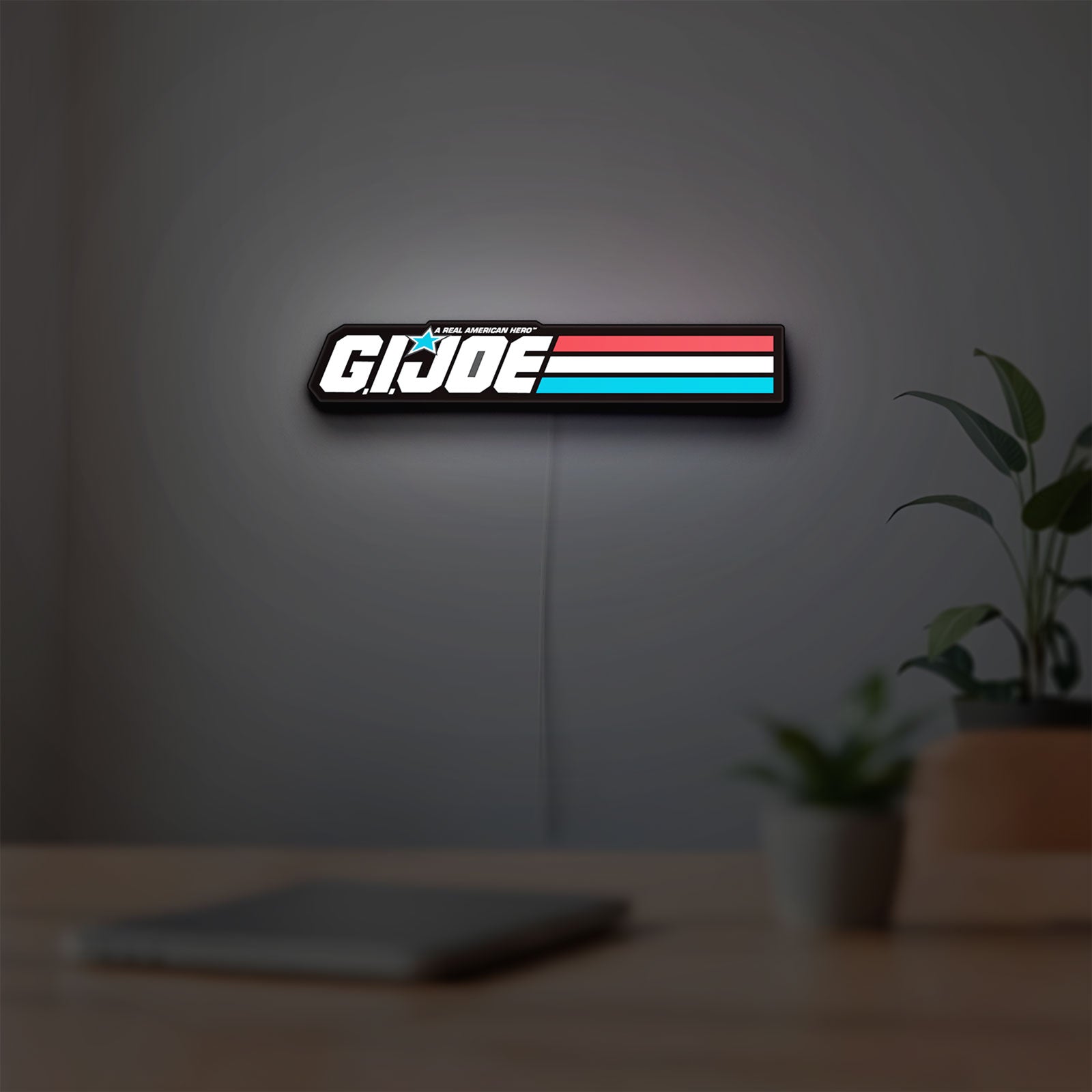 G.I. Joe LED lightbox hanging on a room wall with soft white light