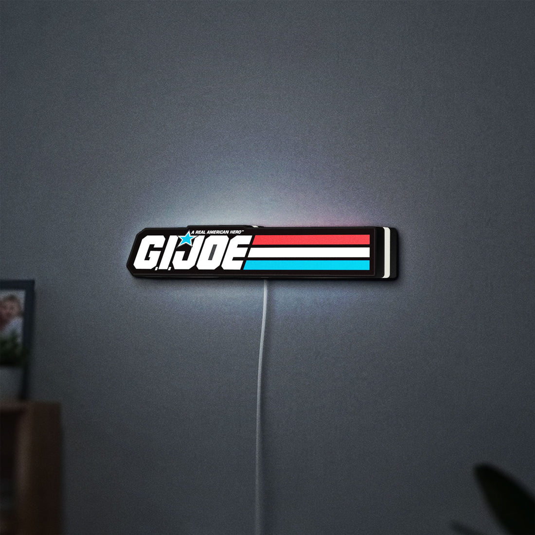 G.I. Joe LED lightbox hanging on a wall with white glow