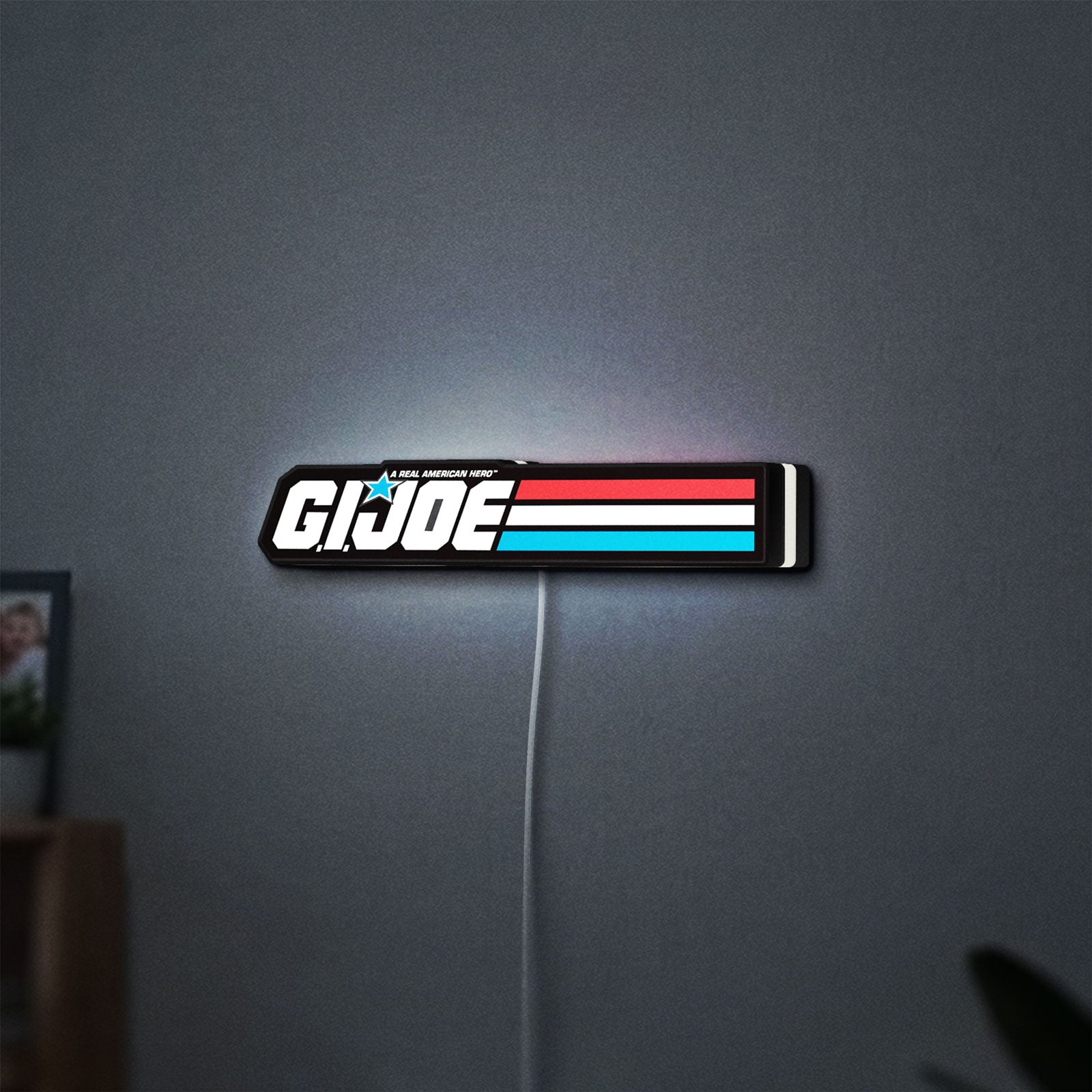 G.I. Joe LED lightbox hanging on a wall with white glow
