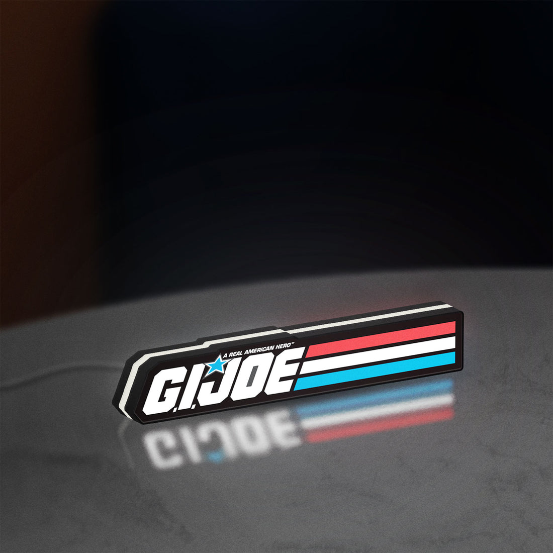 G.I. Joe LED lightbox hanging on a wall with white glow