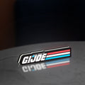 G.I. Joe LED lightbox standing on a desk from an angled side view with white glow