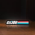 Front view of G.I. Joe LED lightbox sign glowing on a wooden desk