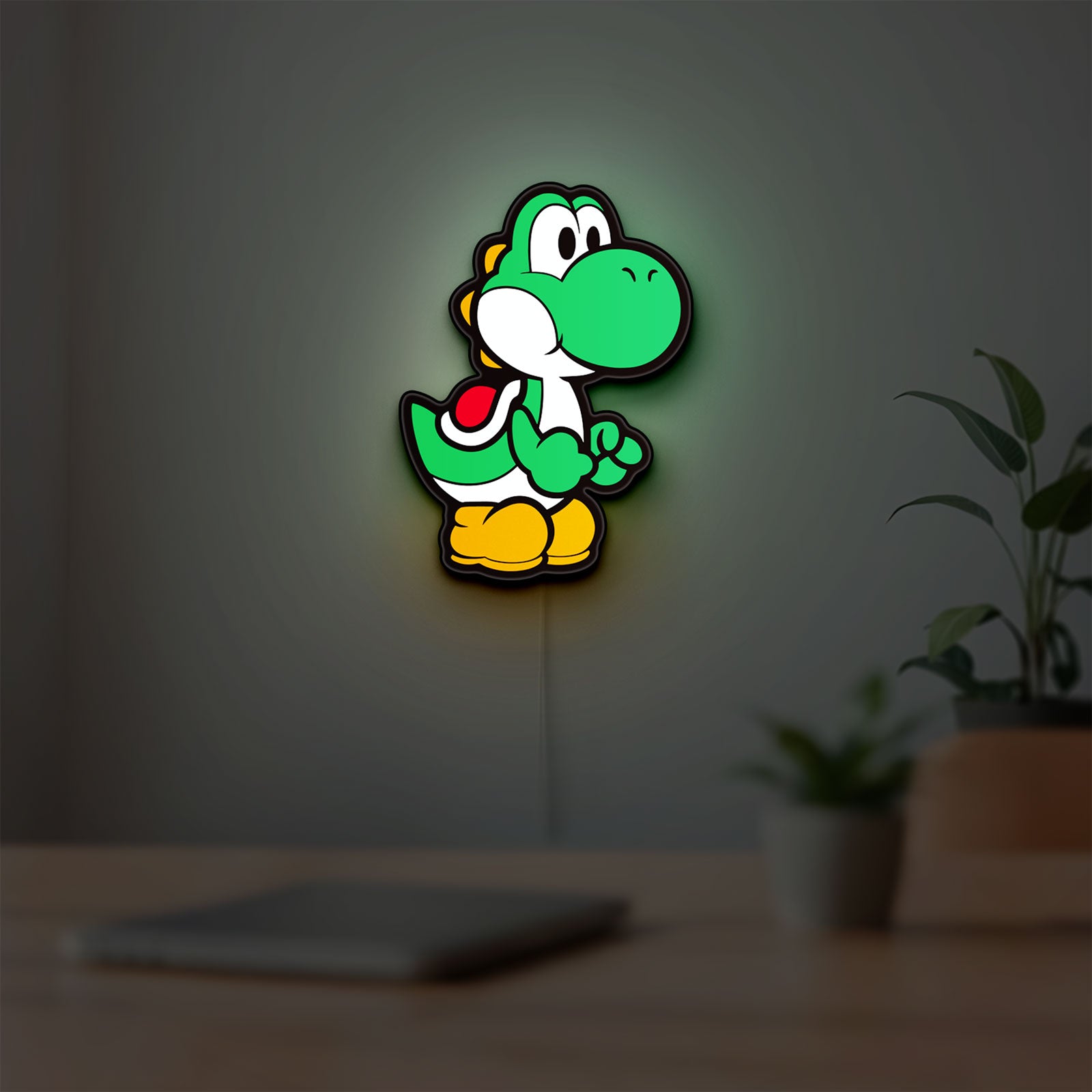 Yoshi LED lightbox hanging on a room wall with soft green light