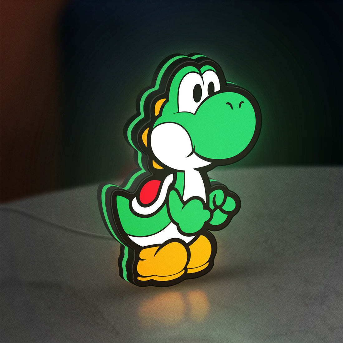 Yoshi LED lightbox hanging on a wall with green glow