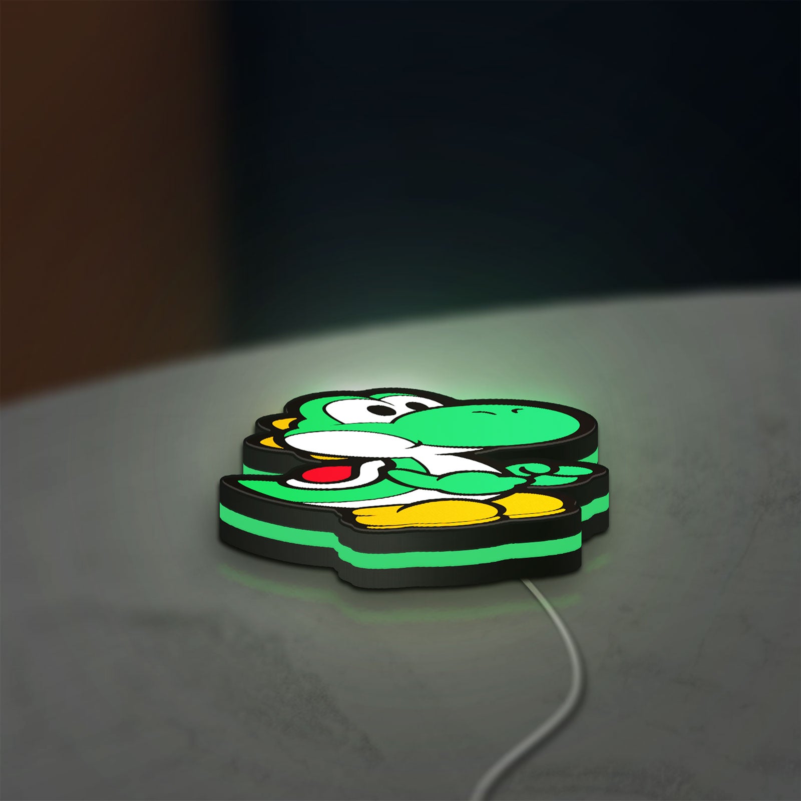 Yoshi LED lightbox lying flat on a desk with green glow