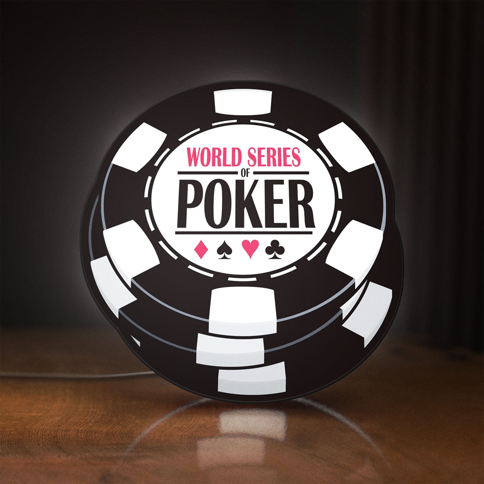 Front view of World Series of Poker LED lightbox sign glowing on a wooden desk