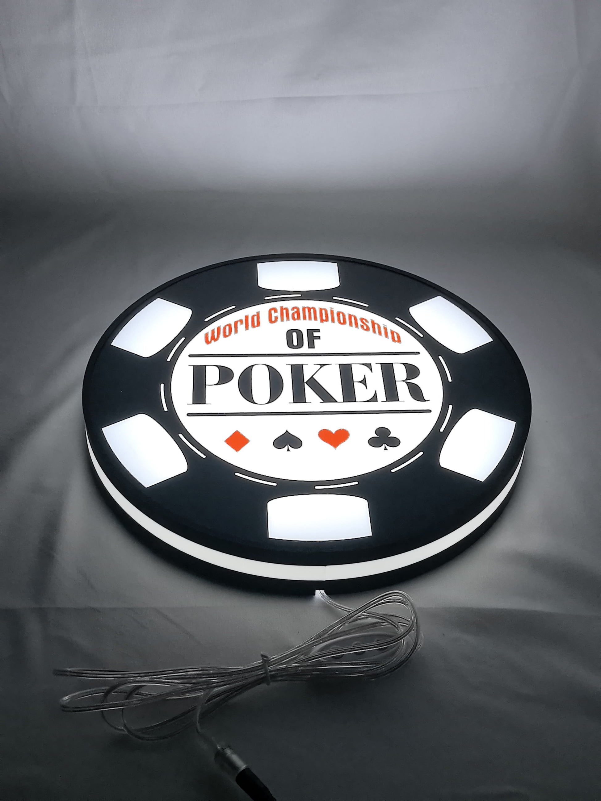 Illuminated flat lay angled view of World Championship Poker 3D LED Sign in 30cm, unique wall art for desk and room decor
