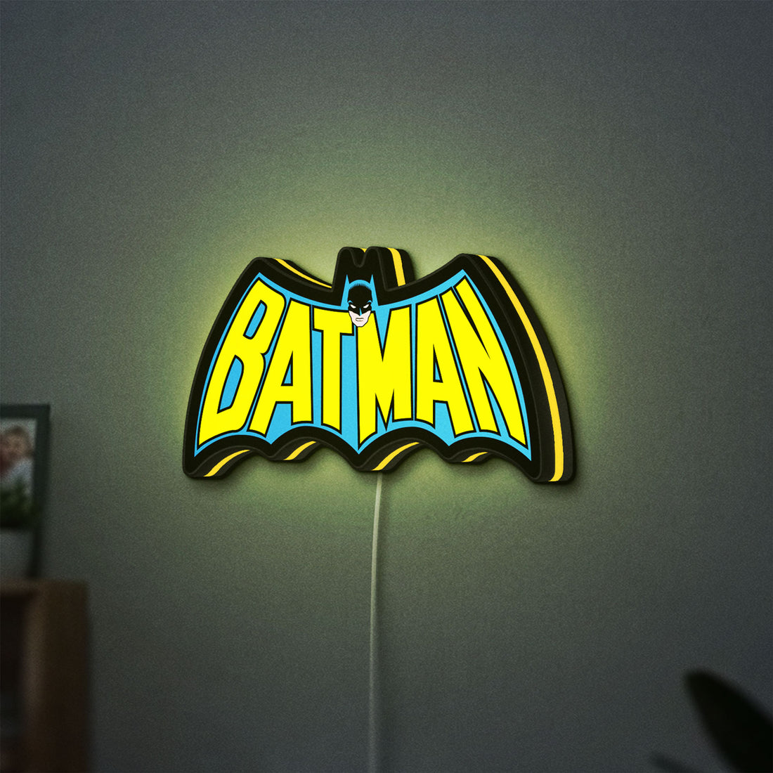 Batman LED lightbox hanging on a wall with yellow glow
