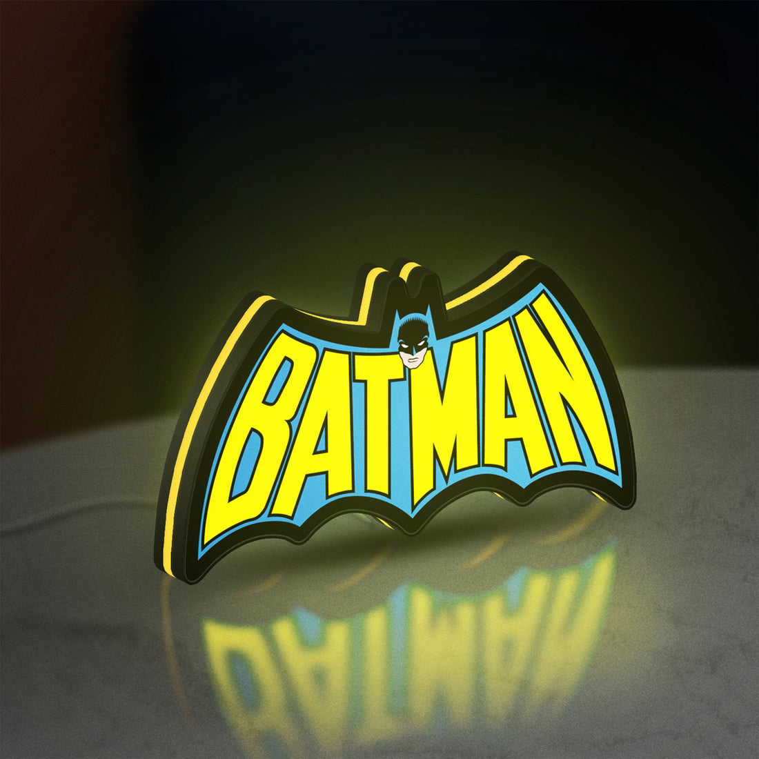 Batman LED lightbox hanging on a wall with yellow glow