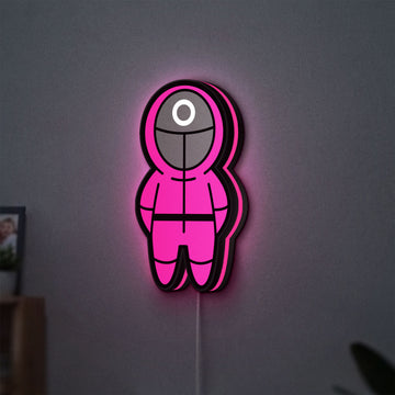 Squid Game LED lightbox hanging on a wall with pink glow