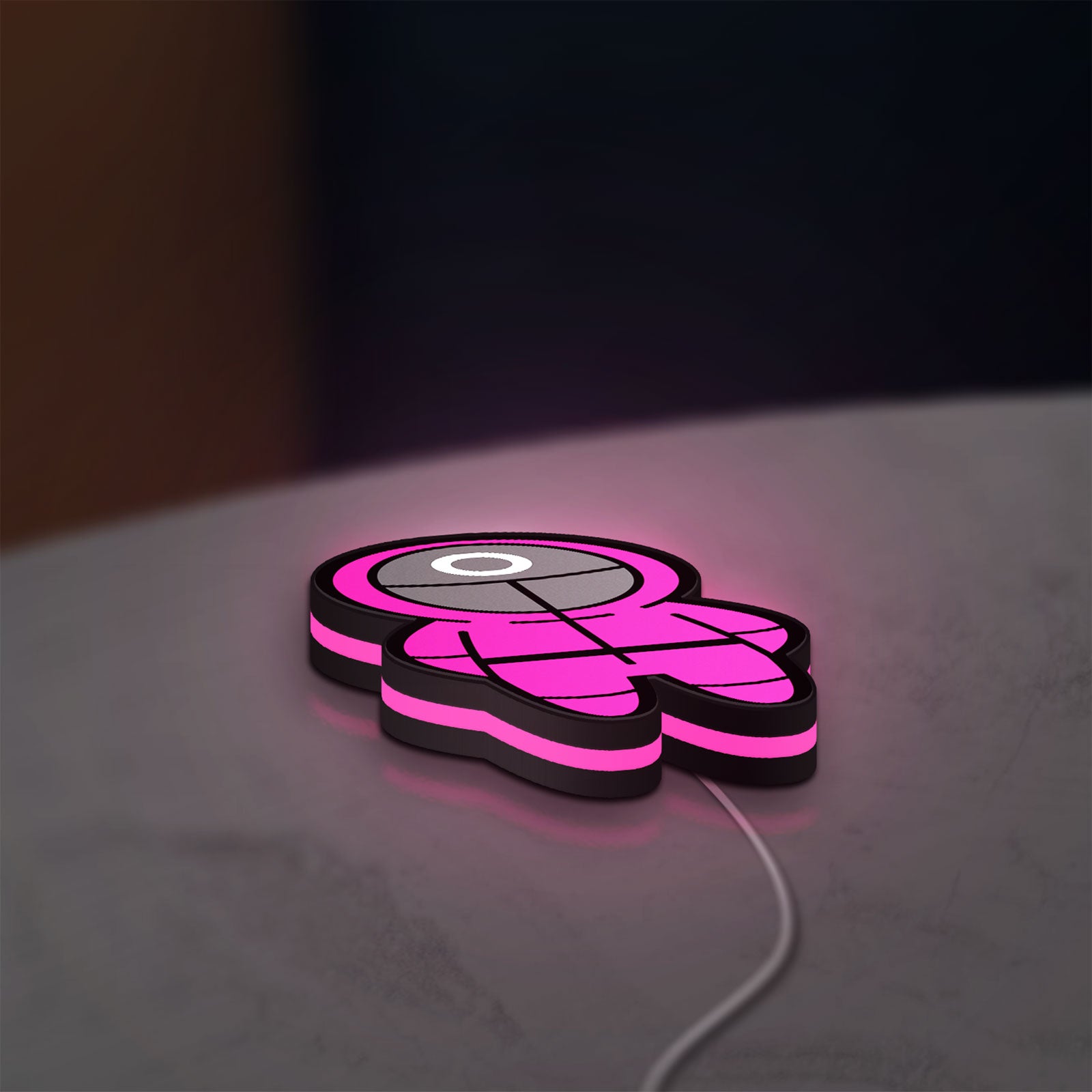 Squid Game LED lightbox lying flat on a desk with pink glow