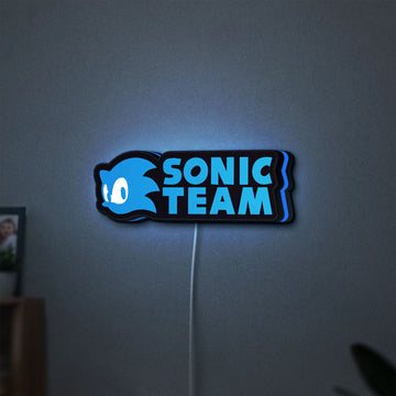 Sonic Team LED lightbox hanging on a wall with blue glow