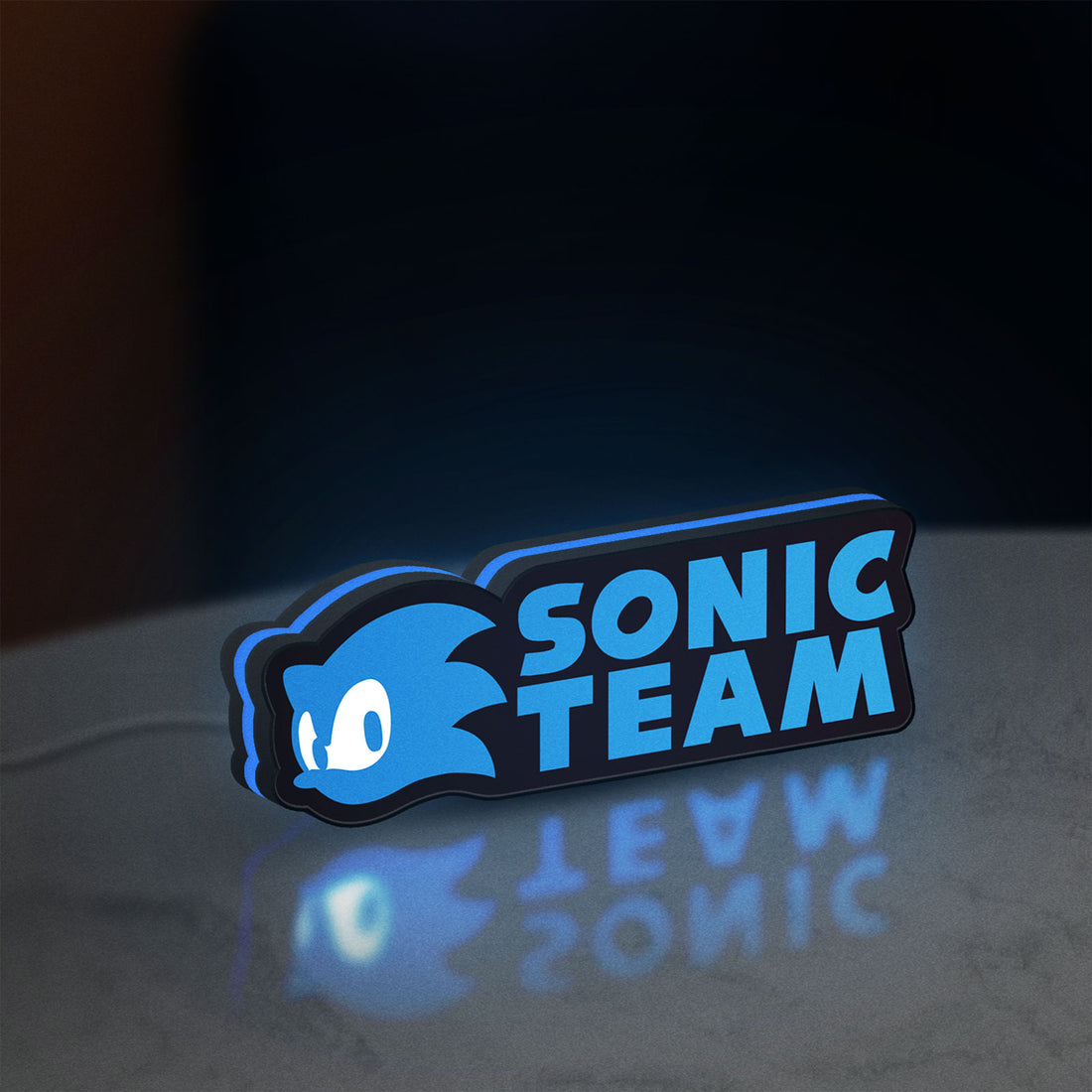 Sonic Team LED lightbox hanging on a wall with blue glow