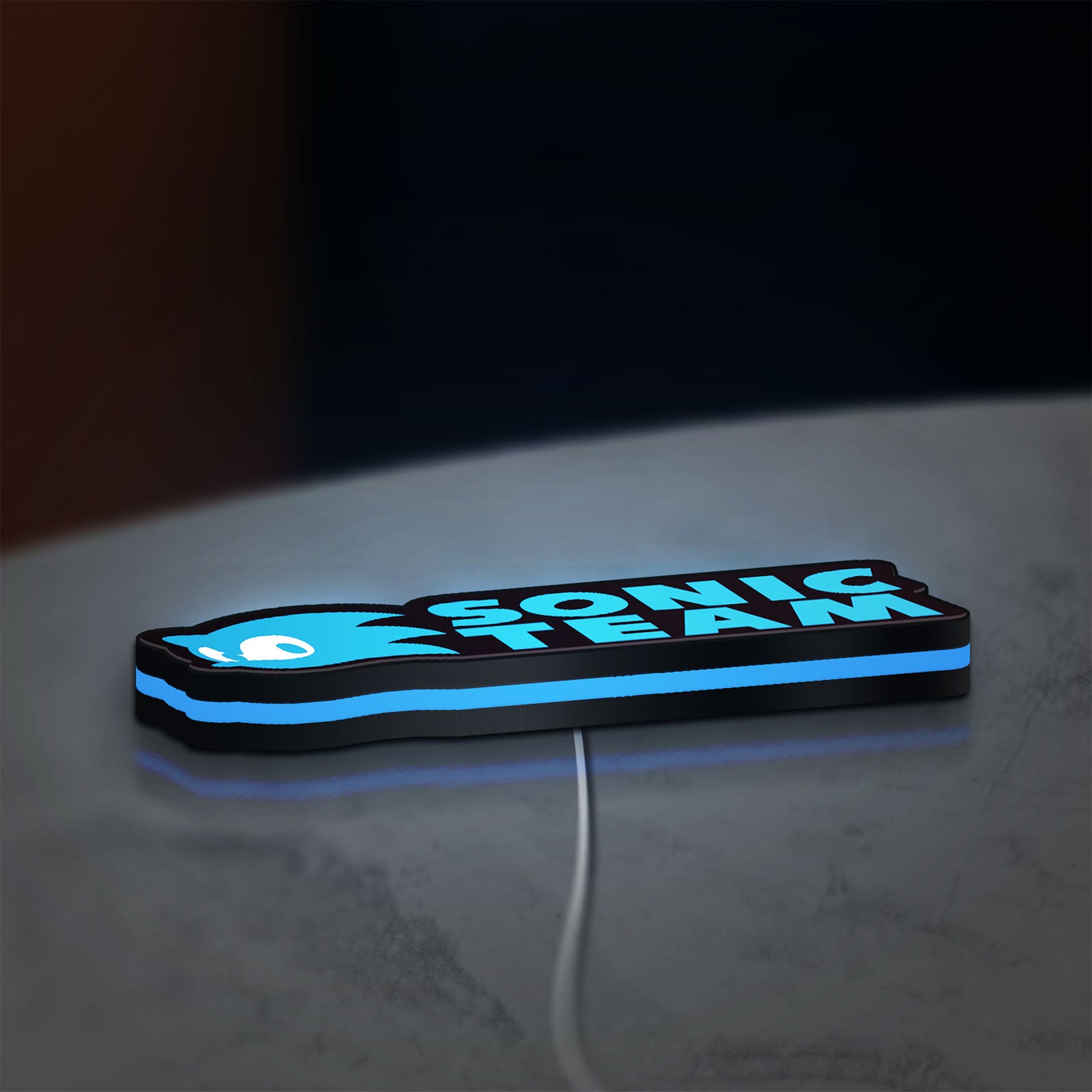 Sonic Team LED lightbox lying flat on a desk with blue glow