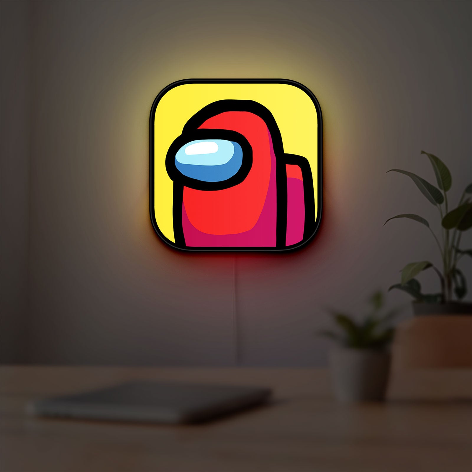 Among Us LED lightbox hanging on a room wall with soft yellow light