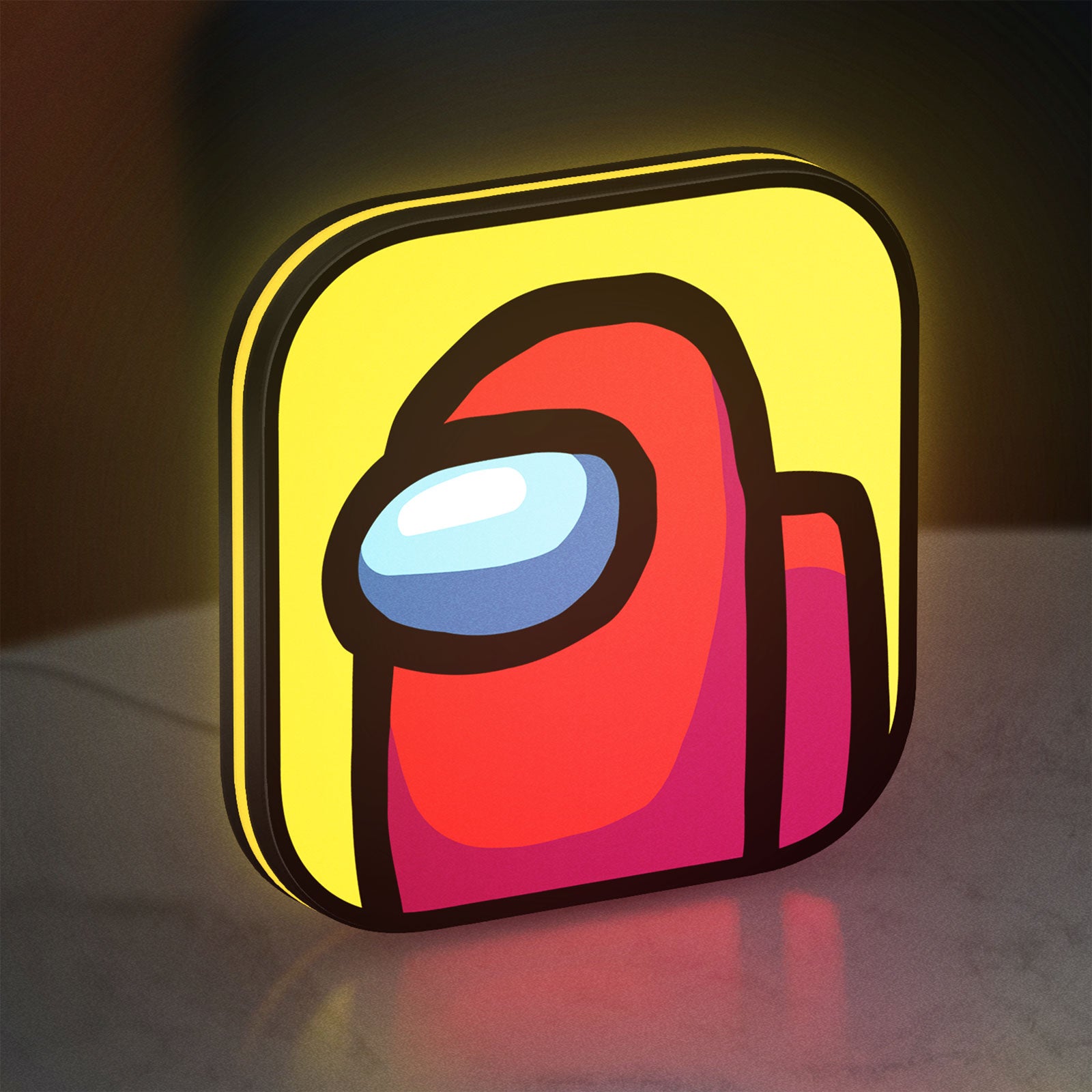 Among Us LED lightbox standing on a desk from an angled side view with yellow glow