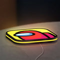 Among Us LED lightbox lying flat on a desk with yellow glow