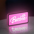 Barbie LED lightbox standing on a desk from an angled side view with pink glow