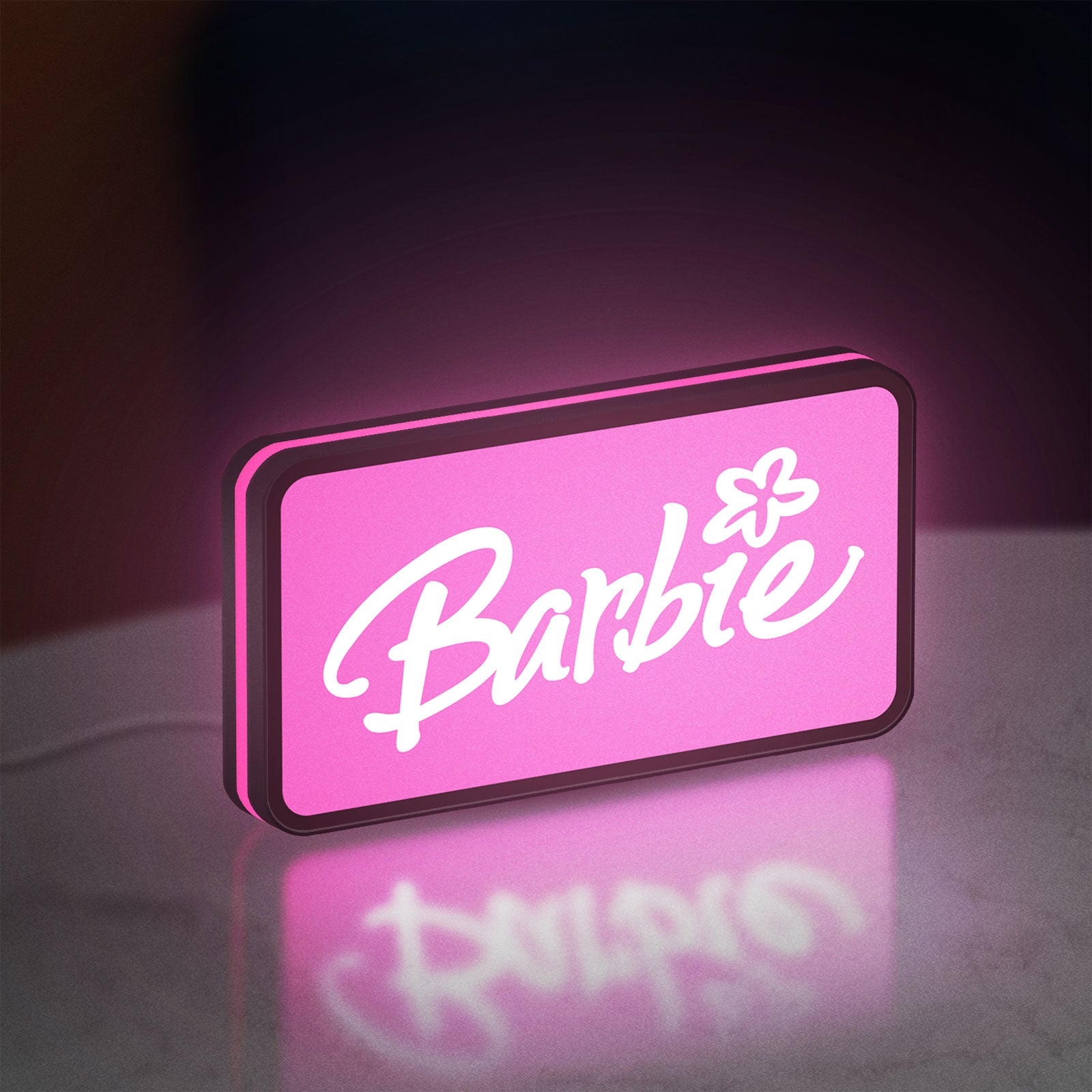 Barbie LED lightbox standing on a desk from an angled side view with pink glow