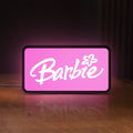 Front view of Barbie LED lightbox sign glowing on a wooden desk