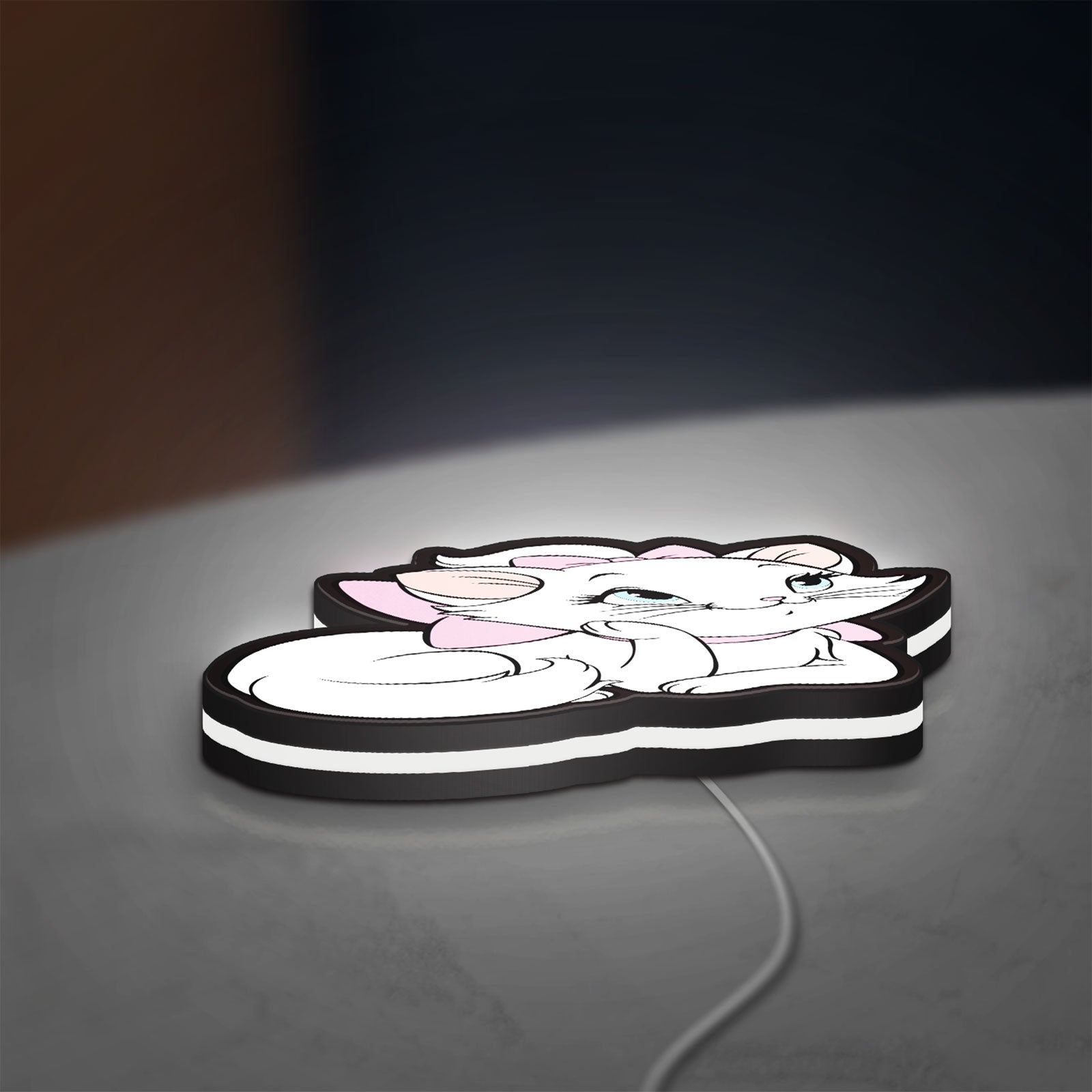Marie Aristocats LED lightbox lying flat on a desk with white glow