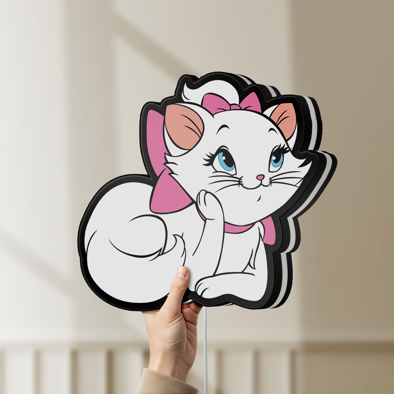 Unlit Marie Aristocats LED lightbox held by hand to show size and details
