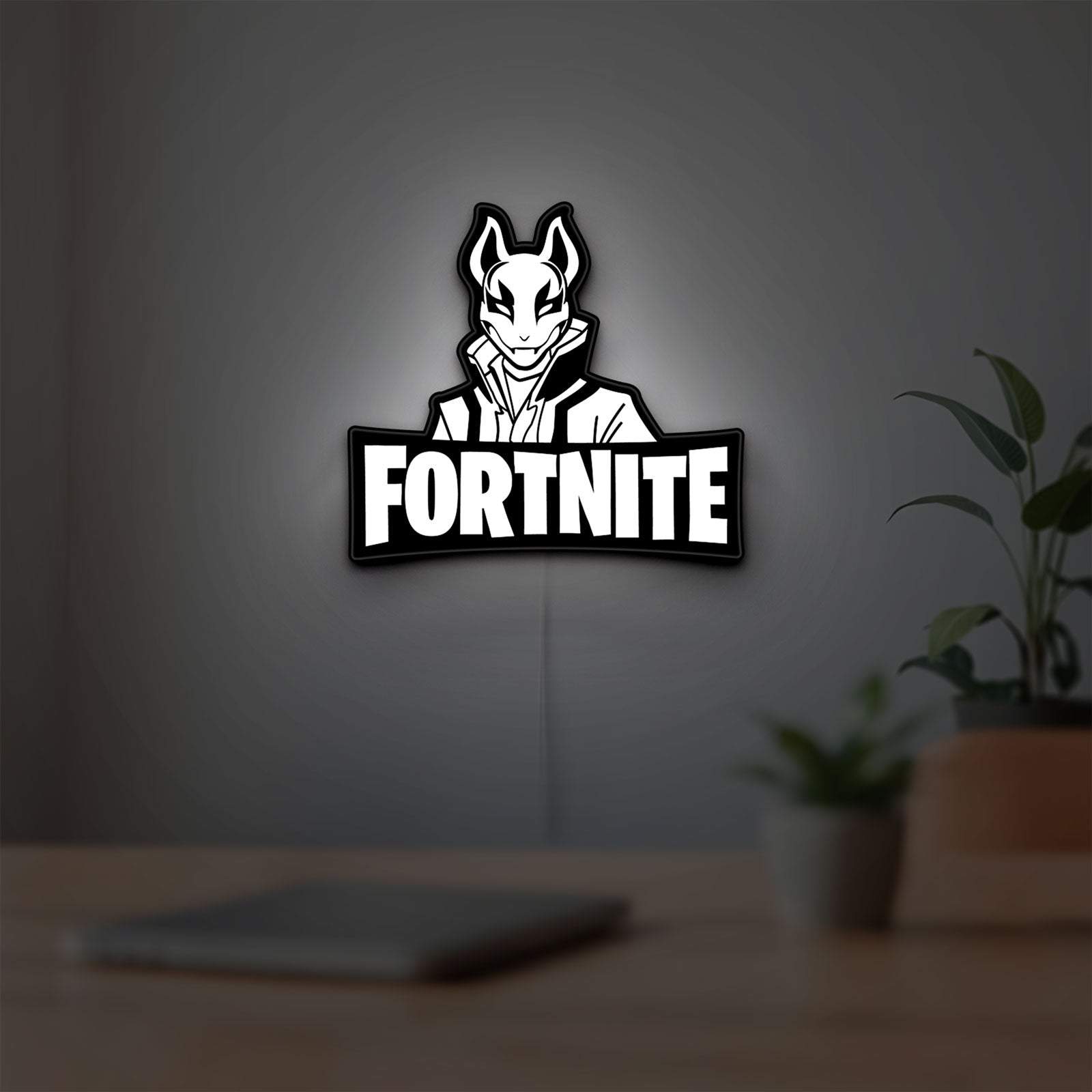 Fortnite LED lightbox hanging on a room wall with soft white light