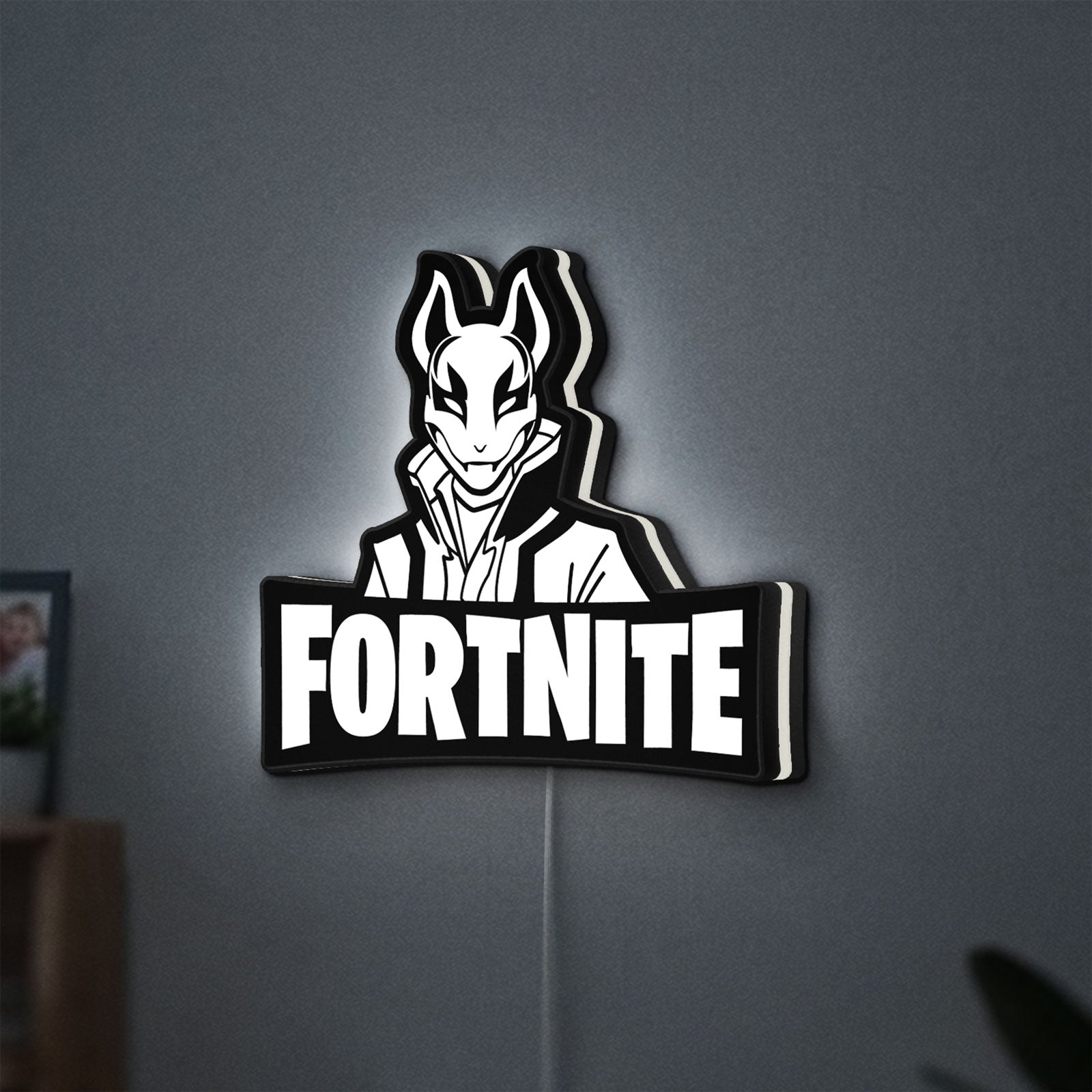 Fortnite LED lightbox hanging on a wall with white glow