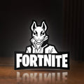 Front view of Fortnite LED lightbox sign glowing on a wooden desk
