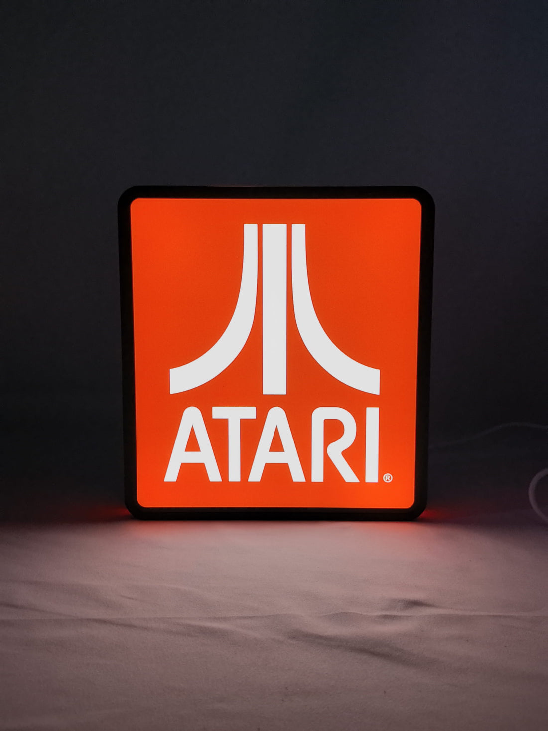 Illuminated front view standing of Atari Illuminated Sign in 20cm, unique wall art for desk and room decor