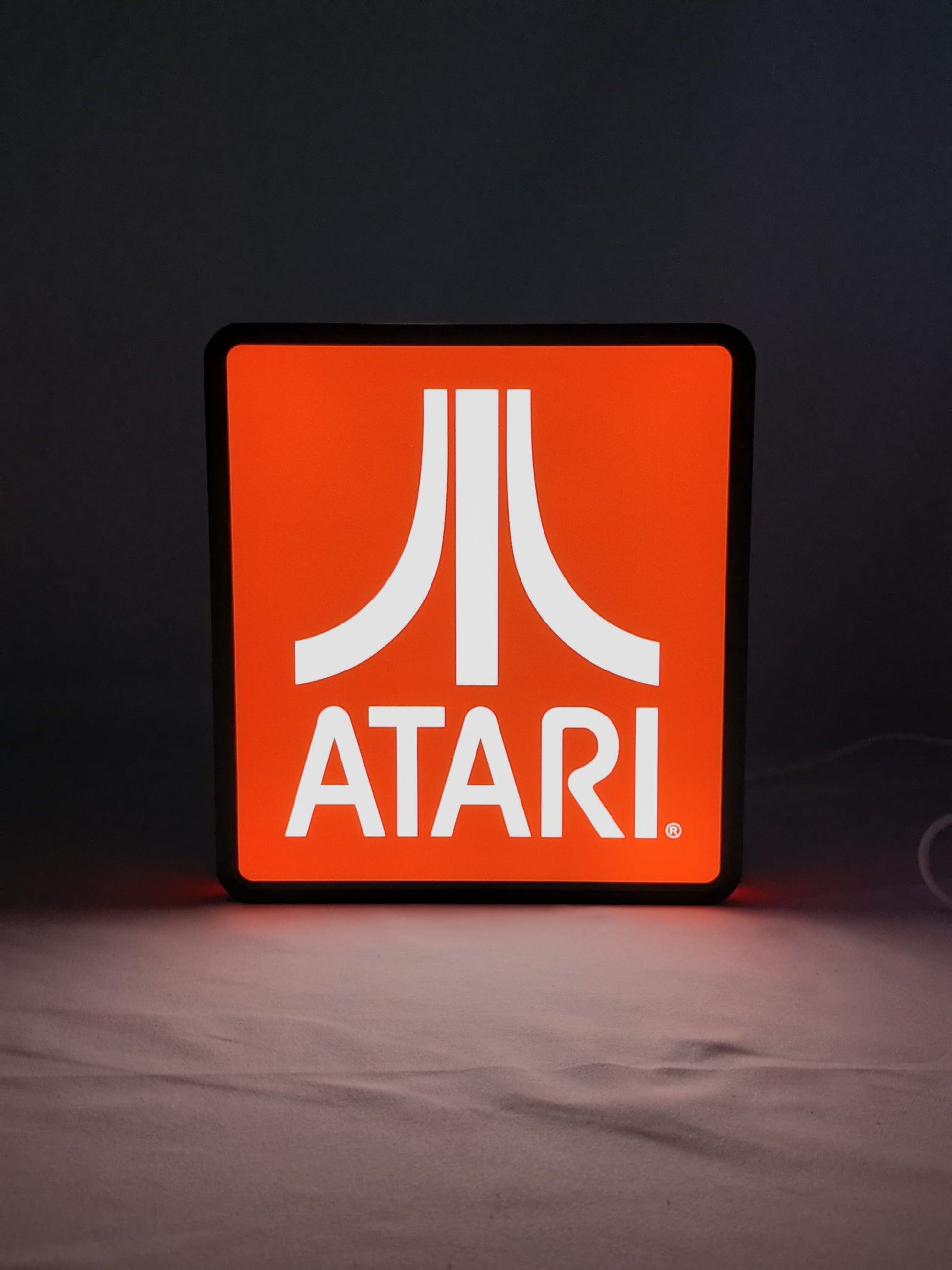 Illuminated front view standing of Atari Illuminated Sign in 20cm, unique wall art for desk and room decor