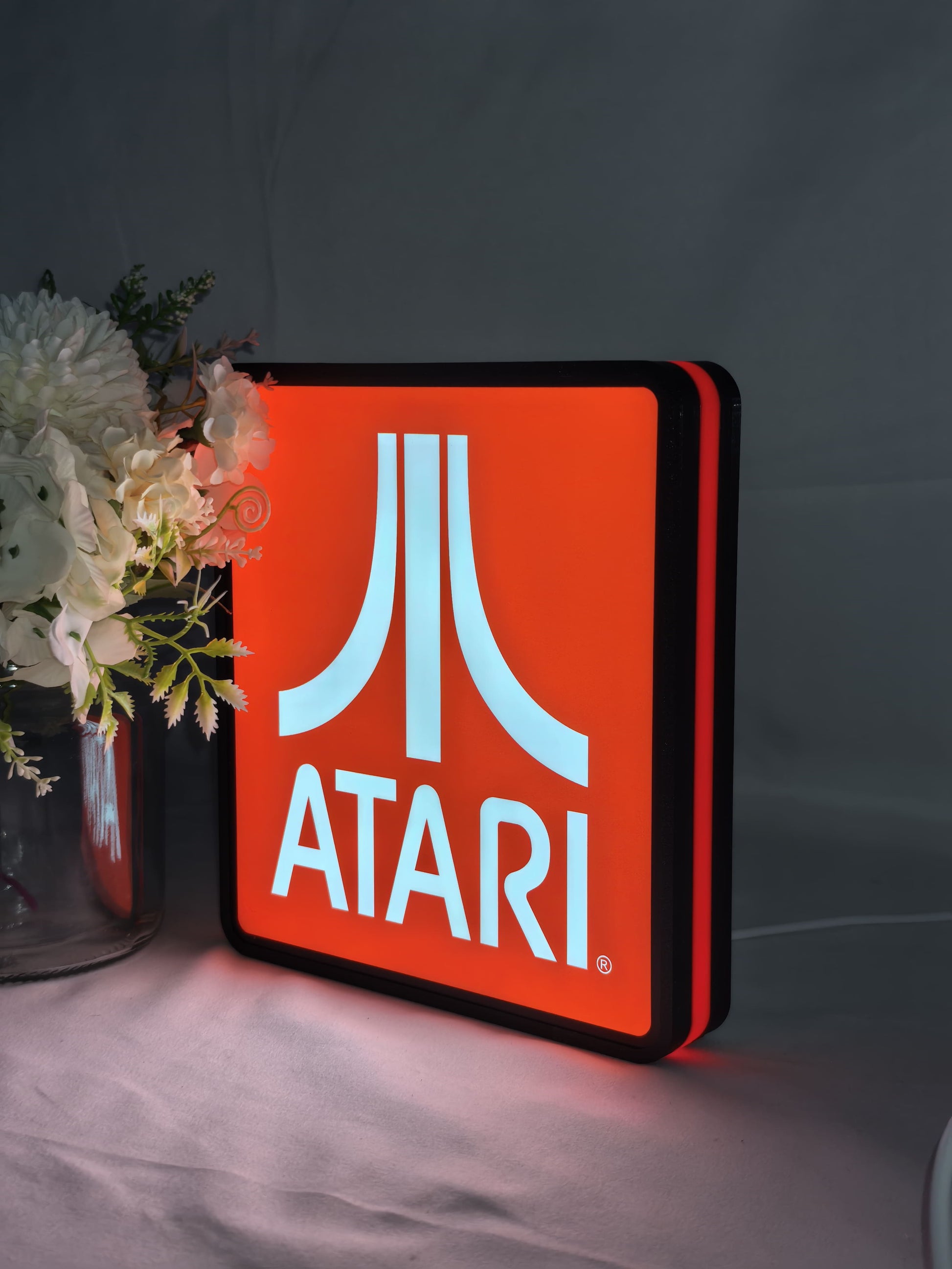 Atari LED Light Box (20cm) - Illuminated angled view standing, unique wall art for desk and room decor