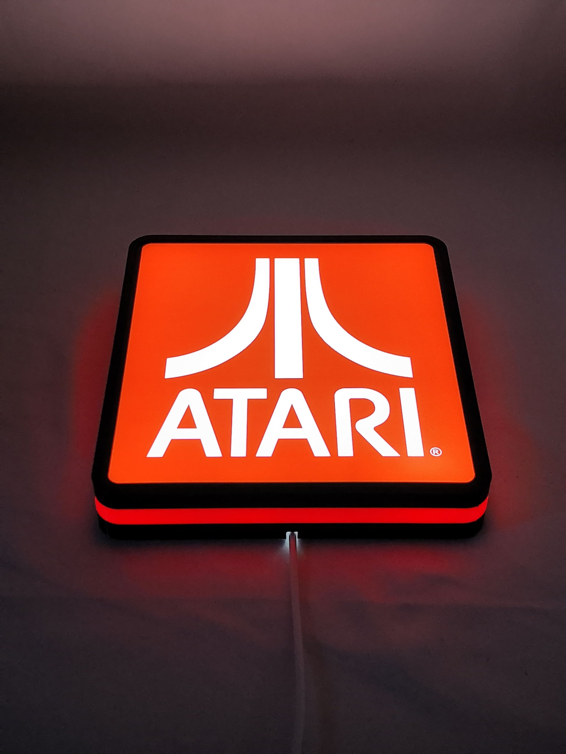 20cm Atari Glowing Wall Art - Illuminated flat lay angled view, unique wall art for desk and room decor