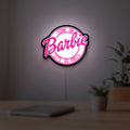 Barbie LED lightbox hanging on a room wall with soft pink light