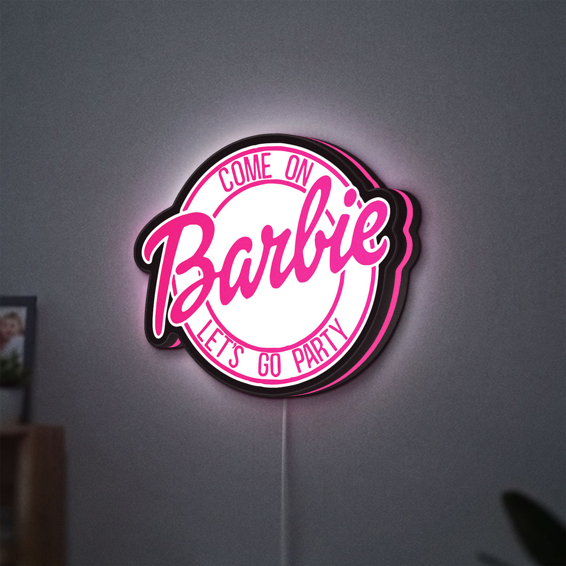 Barbie LED lightbox hanging on a wall with pink glow