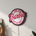 Unlit Barbie LED lightbox mounted on a wall in daylight