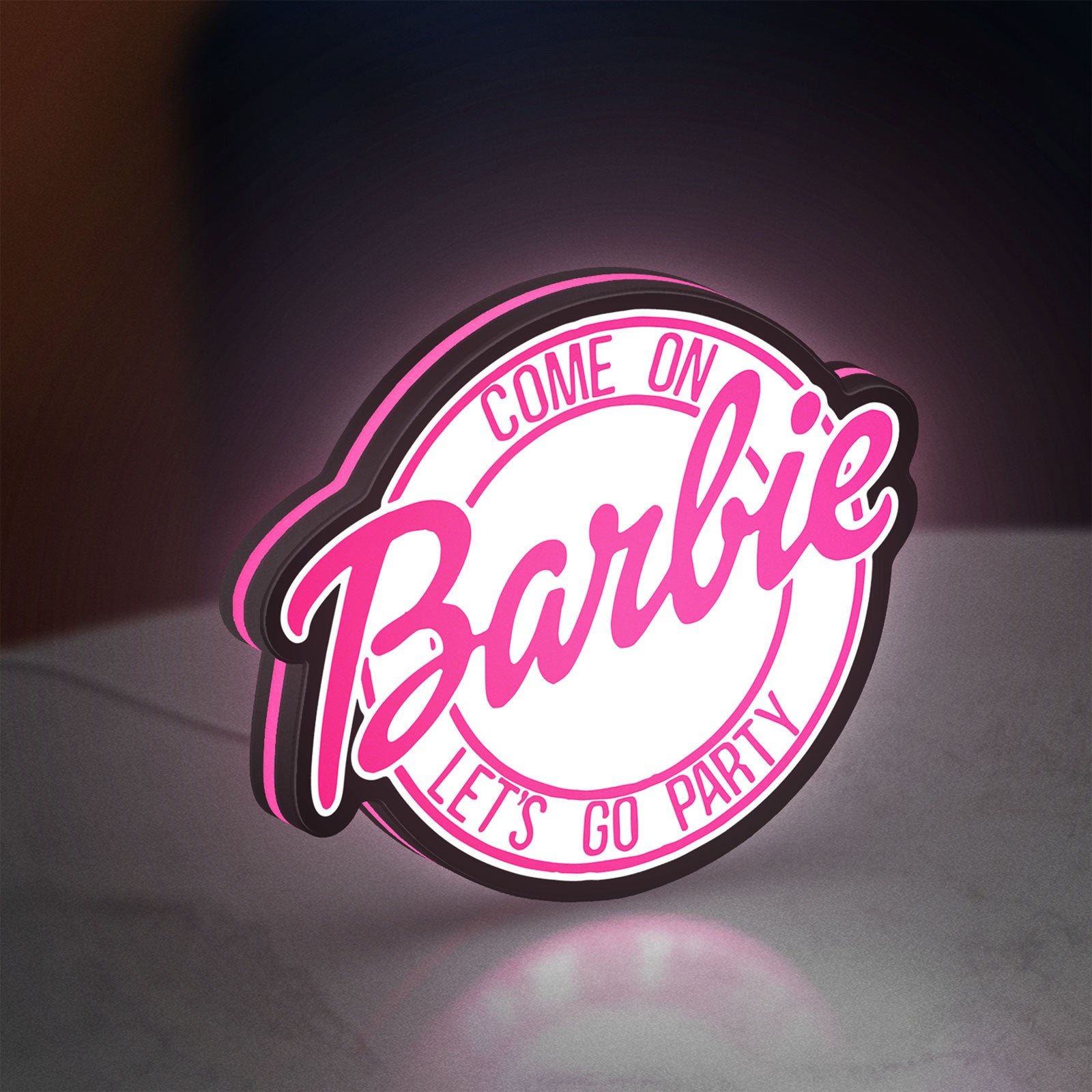 Barbie LED lightbox standing on a desk from an angled side view with pink glow