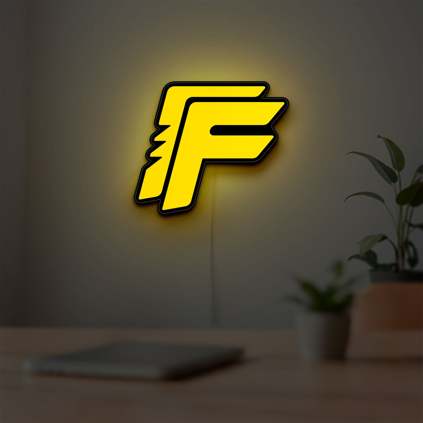 Free Fire LED lightbox hanging on a room wall with soft yellow light