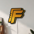 Unlit Free Fire LED lightbox mounted on a wall in daylight