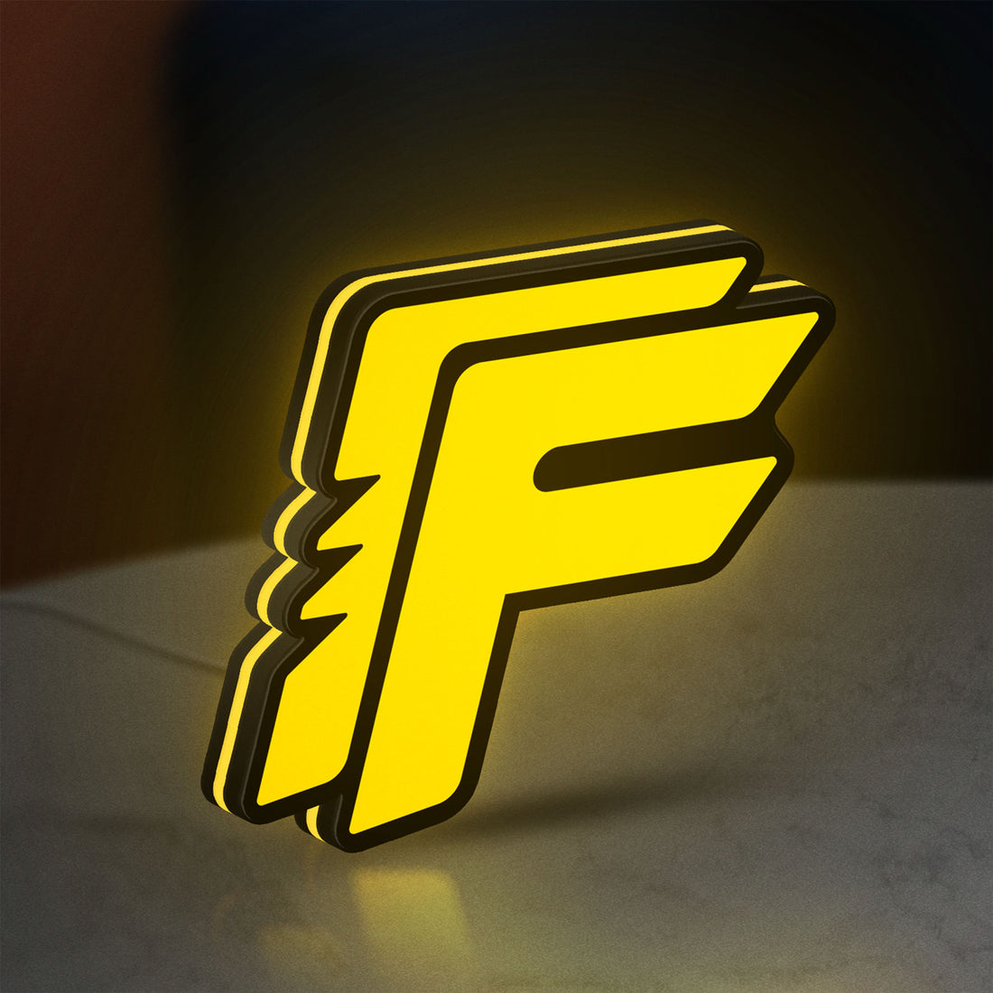 Free Fire LED lightbox hanging on a wall with yellow glow