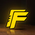 Front view of Free Fire LED lightbox sign glowing on a wooden desk