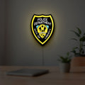 Liberty City Police LED lightbox hanging on a room wall with soft yellow light