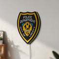 Unlit Liberty City Police LED lightbox mounted on a wall in daylight