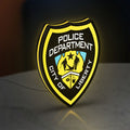 Liberty City Police LED lightbox standing on a desk from an angled side view with yellow glow