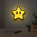 Super Mario Star LED lightbox hanging on a room wall with soft yellow light