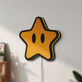 Unlit Super Mario Star LED lightbox mounted on a wall in daylight