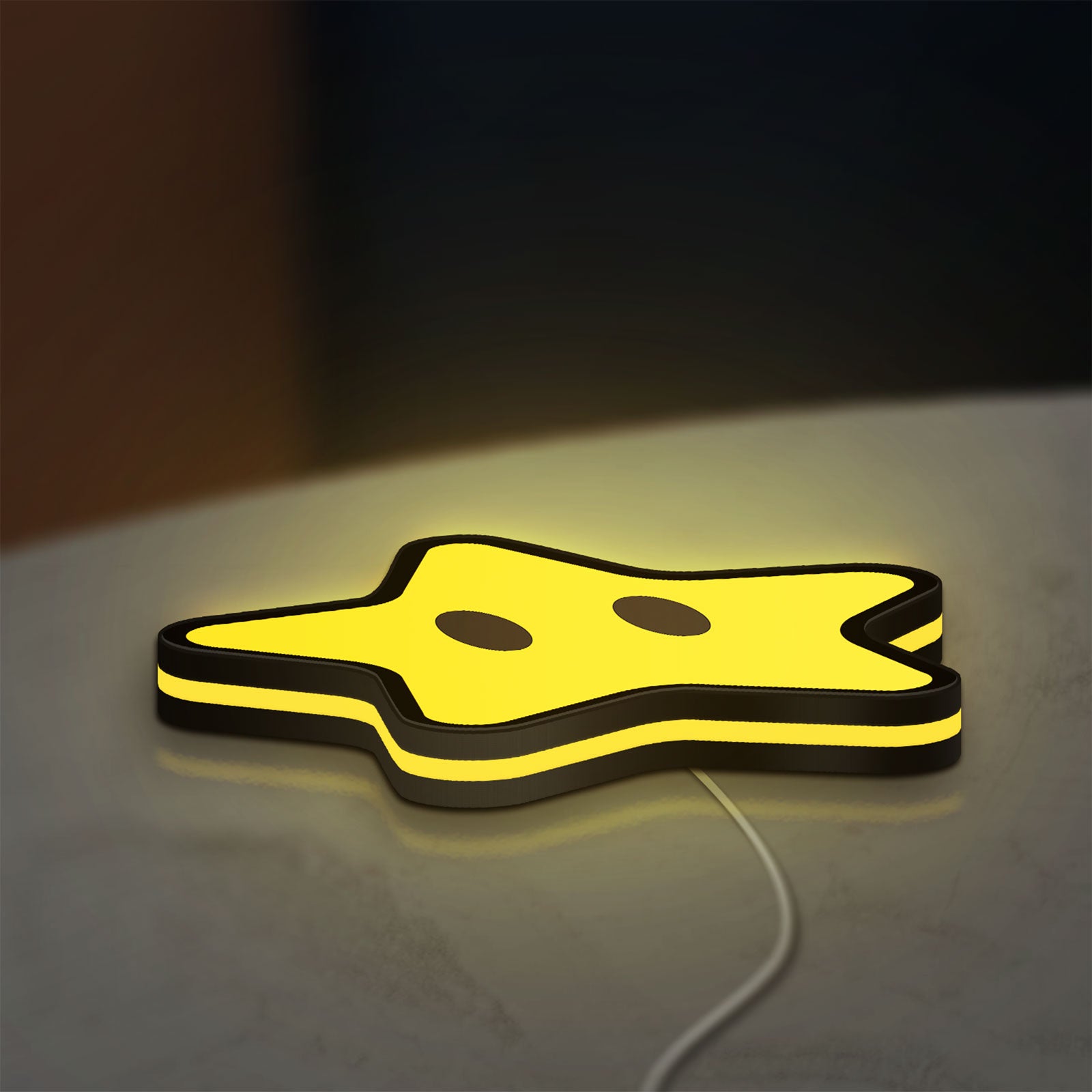Super Mario Star LED lightbox lying flat on a desk with yellow glow