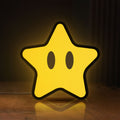 Front view of Super Mario Star LED lightbox sign glowing on a wooden desk