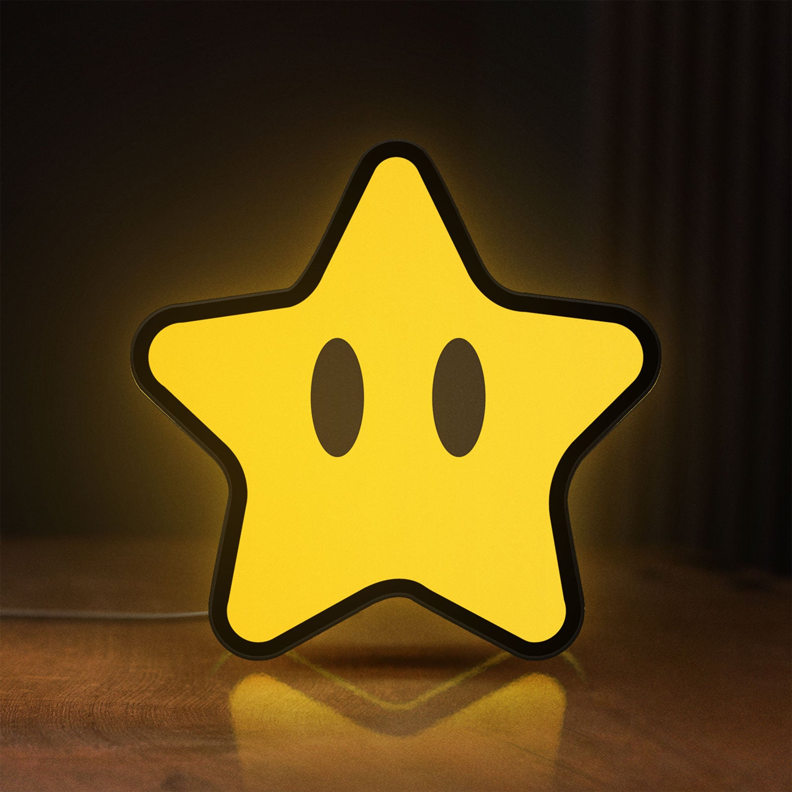 Front view of Super Mario Star LED lightbox sign glowing on a wooden desk