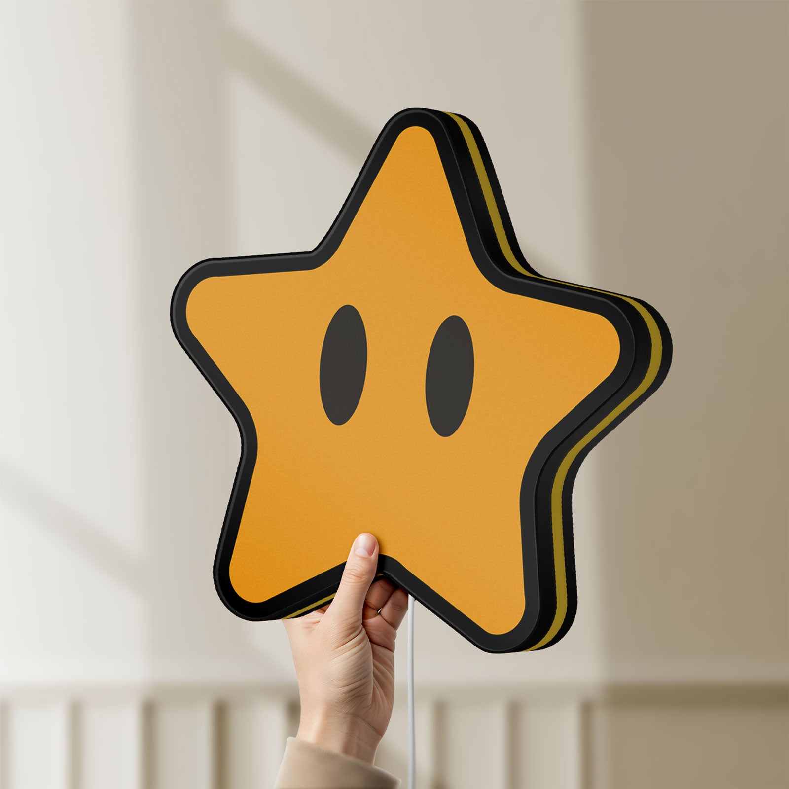Unlit Super Mario Star LED lightbox held by hand to show size and details